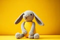 grey soft hare on yellow background cute kids knitted toys