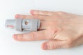 Grey splint for damaged finger injuries on a broken middle finger Royalty Free Stock Photo