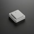 A grey, square electrical switch is mounted on a flat, black surface. The switch has a Royalty Free Stock Photo