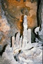 Grey stalagmites formed by mineral deposits and dripping water Royalty Free Stock Photo
