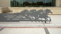 Grey steel cut out of a herd of horses running in front of the Hereford Center at the University of Texas at Arlington.