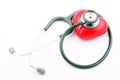 Grey stethoscope on red heart shape with white background