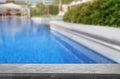 Grey stone deck near swimming pool on sunny day. Space for text Royalty Free Stock Photo