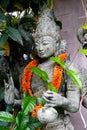 Grey stone statue head face of Buddha as symbol of harmony, Buddhism religion. Place for meditation in asian garden Royalty Free Stock Photo