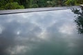 grey stormy sky reflected in swimming pool water