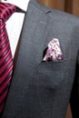 Grey suit with red patterned tie Royalty Free Stock Photo