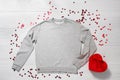 Grey sweatshirt mockup. Valentines Day concept shirt, giftbox heart shape on wooden background. Copy space, template blank front Royalty Free Stock Photo