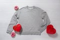 Grey sweatshirt mockup. Valentines Day concept shirt, giftbox heart shape on wooden background. Copy space, template blank front Royalty Free Stock Photo