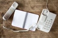 Grey telephone and blank notebook