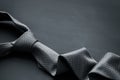 Grey tie on dark background