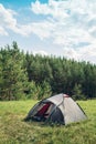 Grey tourist tent in summer forest