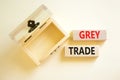 Grey trade symbol. Concept words Grey trade on wooden block. Beautiful white table white background. Empthy opened wooden chest.