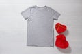 Grey tshirt mockup. Valentines Day concept shirt, gift boxes heart shape on wooden background. Copy space, template blank front