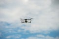 The grey unmanned aerial vehicle against a blue sky backdrop, A drone soaring in the sky
