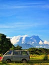 Grey van with mount kinabalu and blue sky background. Royalty Free Stock Photo