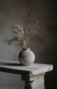 a grey vase sits on top of a white table Royalty Free Stock Photo