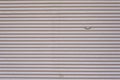 Grey vintage striped door, closeup of garage steel wall texture, horizontal lines pattern, background Royalty Free Stock Photo