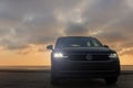 Grey Volkswagen Tiguan against a dramatic sky Royalty Free Stock Photo