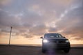 Grey Volkswagen Tiguan against a dramatic sky Royalty Free Stock Photo