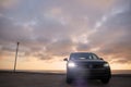 Grey Volkswagen Tiguan against a dramatic sky