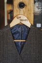 Grey waistcoat for a gentelman hangs on the peg with lettering groom