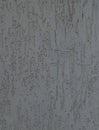 Grey wall, texture, background. Nondescript and darkened building wall. Plastered decorated surface with vertical embossed pattern Royalty Free Stock Photo