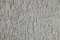 Grey wall, texture, background. Plastered building wall. Decorated surface with vertical embossed pattern Royalty Free Stock Photo