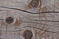 Grey weathered wood texture showing cracks, knots and growth rings