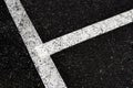 Grey with white line angle on the road and small rock, high angle view dirty white line on surface of old asphalt in countryside
