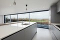 Grey and white open plan kitchen with granite countertop