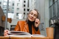 Grey white senior woman reading book while sitting in cafe Royalty Free Stock Photo