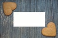 Grey wooden aged background with ginger bread biscuits in two corners wight copy space in middle. Saint valentines frame