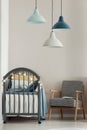 Grey crib in fashionable scandinavian baby bedroom interior Royalty Free Stock Photo