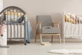 Grey wooden crib in fashionable scandinavian baby bedroom interior Royalty Free Stock Photo