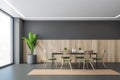 Grey and wooden dining room with chairs and table plant in the corner