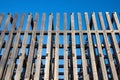 grey wooden laths with a blue sky in the background Royalty Free Stock Photo