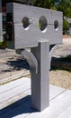 Grey wooden post with pillory or stocks