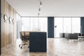 Grey and wooden reception hall and armchairs for clients near window