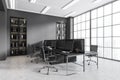 Grey workplace interior with table and pc computer, panoramic window on city view