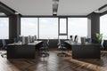 Grey workspace interior with pc monitors and table near panoramic window