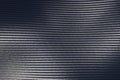 Grey woven carbon fibre sheet surface with light reflection. Royalty Free Stock Photo