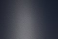 Grey woven carbon fibre sheet surface with light reflection. Royalty Free Stock Photo