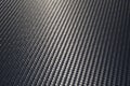 Grey woven carbon fibre sheet surface with light reflection. Royalty Free Stock Photo