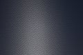Grey woven carbon fibre sheet surface with light reflection Royalty Free Stock Photo