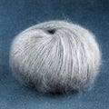 Grey yarn ball of mohair angora wool for knitting on the velve