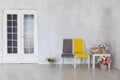 grey and yellow chairs with coffee table with books and flowers Royalty Free Stock Photo