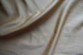 Greyish gold napped fabric in soft folds Royalty Free Stock Photo