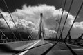 Greyscale of a Cable-stayed bridge with mountains on the background under a cloudy sky Royalty Free Stock Photo