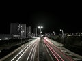 Greyscale high angle view of the red and white car speeding light on the road at night Royalty Free Stock Photo