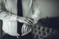 Greyscale of a man is adjusting the buttons on his suit Royalty Free Stock Photo